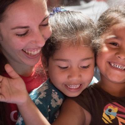 A volunteer and her students clap and sing songs during her teaching work experience in Costa Rica Happy children with their teacher at one of Projects Abroad's volunteer teaching placements in Costa Rica